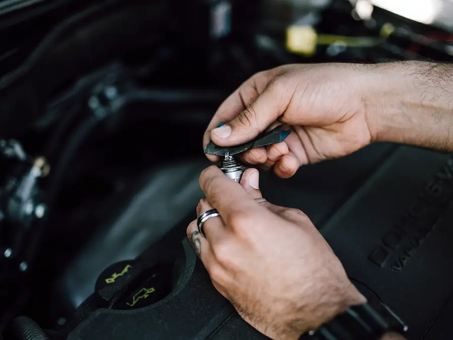 Mechanic's hands working on an engine